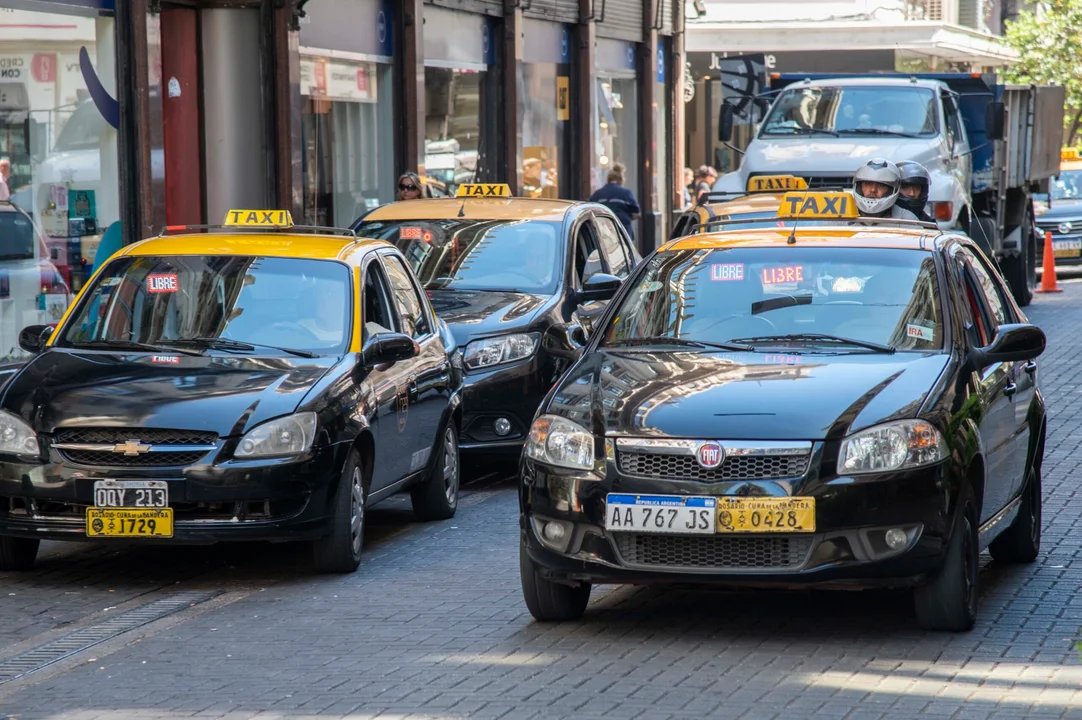 Taxi circulando por una avenida con poco movimiento de pasajeros